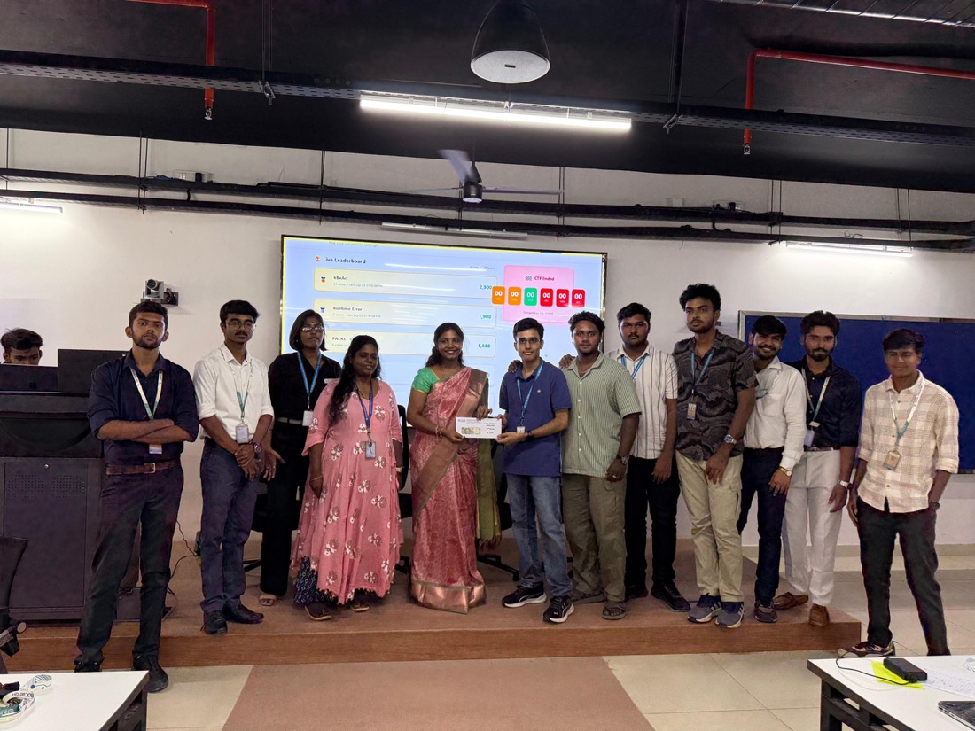 A winning team receiving their prize at CTF 2025, with the leaderboard behind them