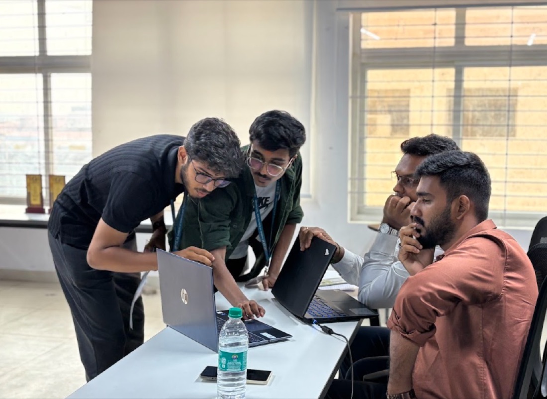 A team working through their idea on laptops at IDEATHON 2.0